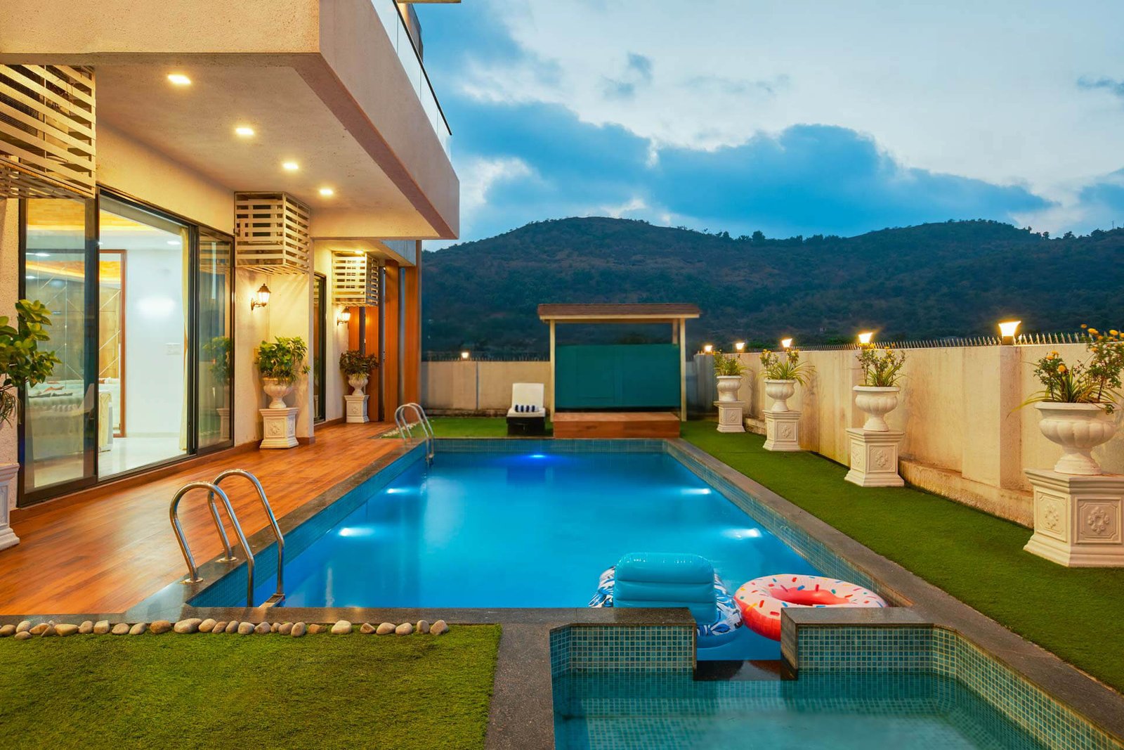 POOL + GAZEBO – Private pool with attached kids' pool, garden gazebo to the side, hills behind.